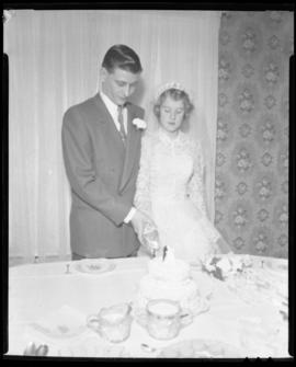 Photograph of Marilyn MacPherson and her husband cutting the wedding cake