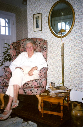 Photograph of Barbara Hinds sitting in a floral armchair