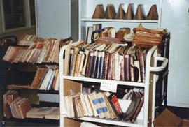 Photograph of a cart full of damaged books