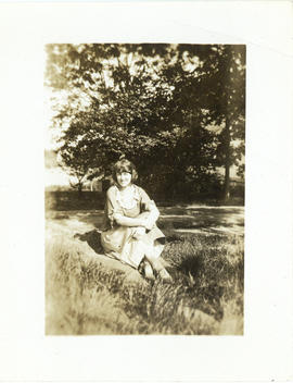 Photograph of a young woman sitting in the grass