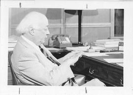Photograph of Henry Hicks sitting at a desk