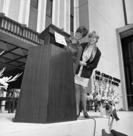 Photograph of an podium in front of the Tupper Building