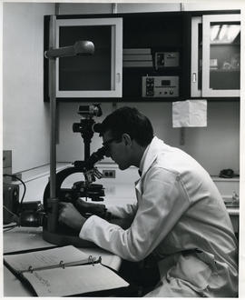 Photograph of D. A. Gibson with microscope