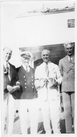 Photograph of Arthur Stanley MacKenzie and three unidentified people on a cruise ship