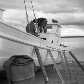 Photograph of a boat called the Joan Ryan sitting on the shore in Fort Chimo, Quebec