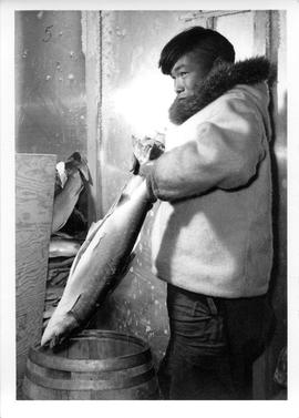 Photograph of an unidentified man holding a fish