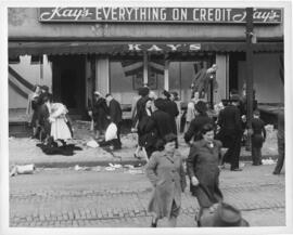Photograph of civilian looters outside the smashed windows of Kay's Department Store on Barringto...