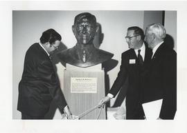 Photograph of James L. Denholme, Donovan F. Miller, and Norman A. M. MacKenzie unveiling a bust