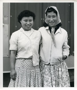 Portrait of two young women with curled hair in Sugluk, Quebec