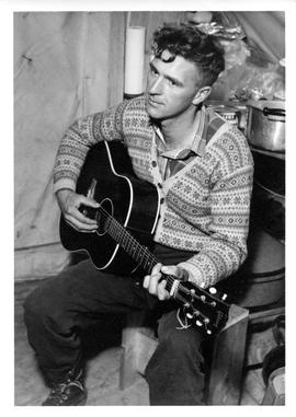 Photograph of an unidentified man playing guitar