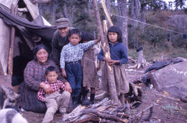 Photograph of a Naskapi family outside of their tent in Davis Inlet, Newfoundland and Labrador