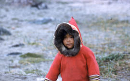 Photograph of a child with a red coat in Cape Dorset, Northwest Territories