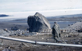 Photograph of an unidentified man and construction equipment in Frobisher Bay, Northwest Territories