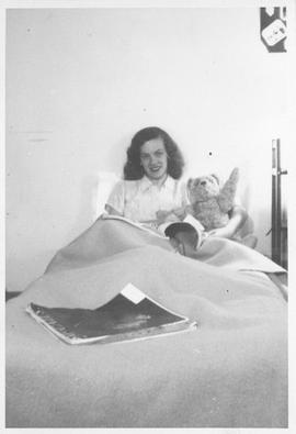Photograph of an unidentified person sitting in bed