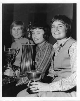 Photograph and a photographic negative of three female athletes