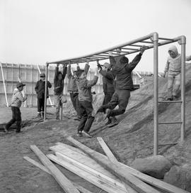 Photograph of children playing on monkey bars in Fort Chimo, Quebec
