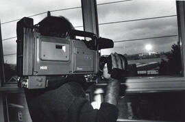 Photograph of person with a video camera