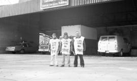 Photograph of three members of CUPE 1392 on strike