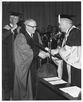 Photograph of Henry Hicks conferring an honorary degree on an unidentified person