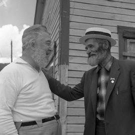 Photograph of Ralph Dunn and Black Mike standing together in Dawson City, Yukon