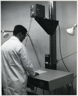Photograph of D.A. Gibson with audio-visual equipment