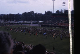 Photograph of a football field with a marching band