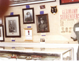 Photograph of a museum display of artifacts and portraits of the Royal Winnipeg Rifles Regiment