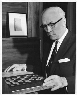 Photograph of Henry Hicks with a stamp collection