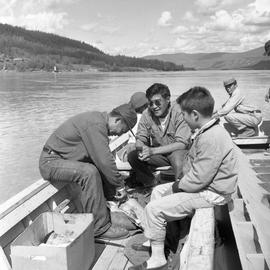 Photograph of Arthur Percy, an unidentified man, and a boy on a boat on the Yukon River