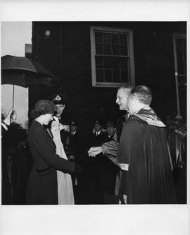 Photograph of Princess Elizabeth and the Duke of Edinburgh being greeted by Lieutenant-Colonel K....