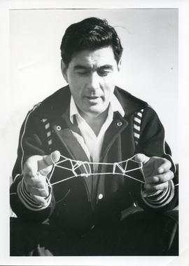 Photograph of George Koneak playing cat's cradle in Fort Chimo, Quebec