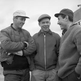 Photograph of Luke Dumas, Jacques Dumas, and George Koneak talking together in Fort Chimo, Quebec