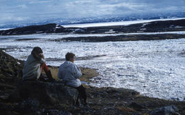 Photograph of Barbara Hinds and another woman sitting on a rock