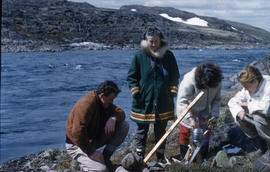 Photograph of Barbara Hinds and three other people making tea outdoors in Frobisher Bay, Northwes...