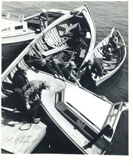 Photograph of lobstermen salvaging a sunken boat at Seal Island, off Cape Sable Island