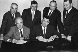 Photograph of Maritime Telephone & Telegraph signing draft collective agreement with the IBEW