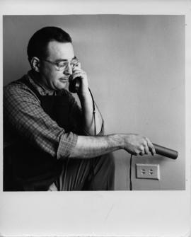Photograph of R.K. Jones holding a phone to his ear