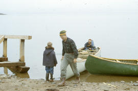 Photograph of Bob Green and two other people with canoes in Frobisher Bay, Northwest Territories