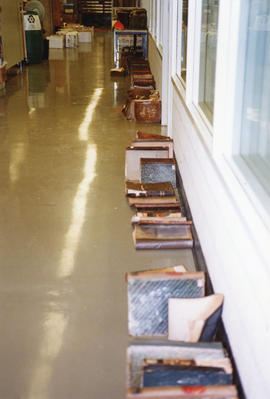 Photograph of a row of books drying out in the corridor after the 1998 Killam fire
