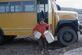 Photograph of a young woman and a bus in Frobisher Bay, Northwest Territories