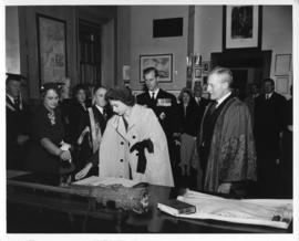 Photograph of Princess Elizabeth signing a guest book in the Macdonald Memorial Library