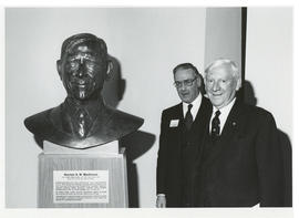 Photograph of Norman A. M. MacKenzie with a bust of himself