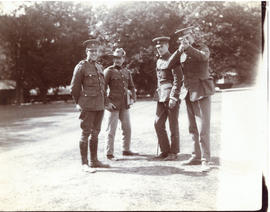 Photograph of four officers in uniform standing on a lawn at Hythe, England