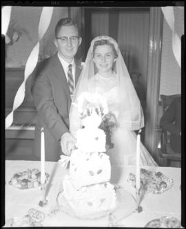 Photograph of Mr. & Mrs. Grice cutting the wedding cake