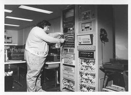 Photograph of an unidentified person with a switchboard