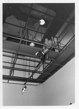 Photograph of an unidentified person setting up lights