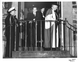 Photograph of E. C. Plow, Lady Dunn, and others exiting a building