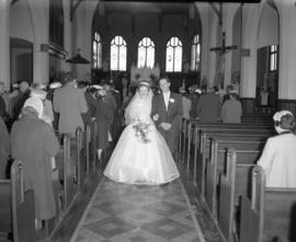 Photograph of Mr. & Mrs. Wright walking down the aisle at their wedding
