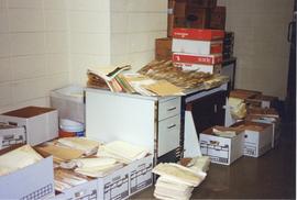 Photograph of piles of files and boxes