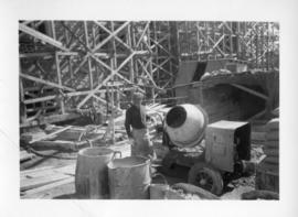 Photograph of a man with a cement mixer